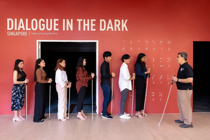 A guide from Dialogue in the Dark preparing to lead a group tour