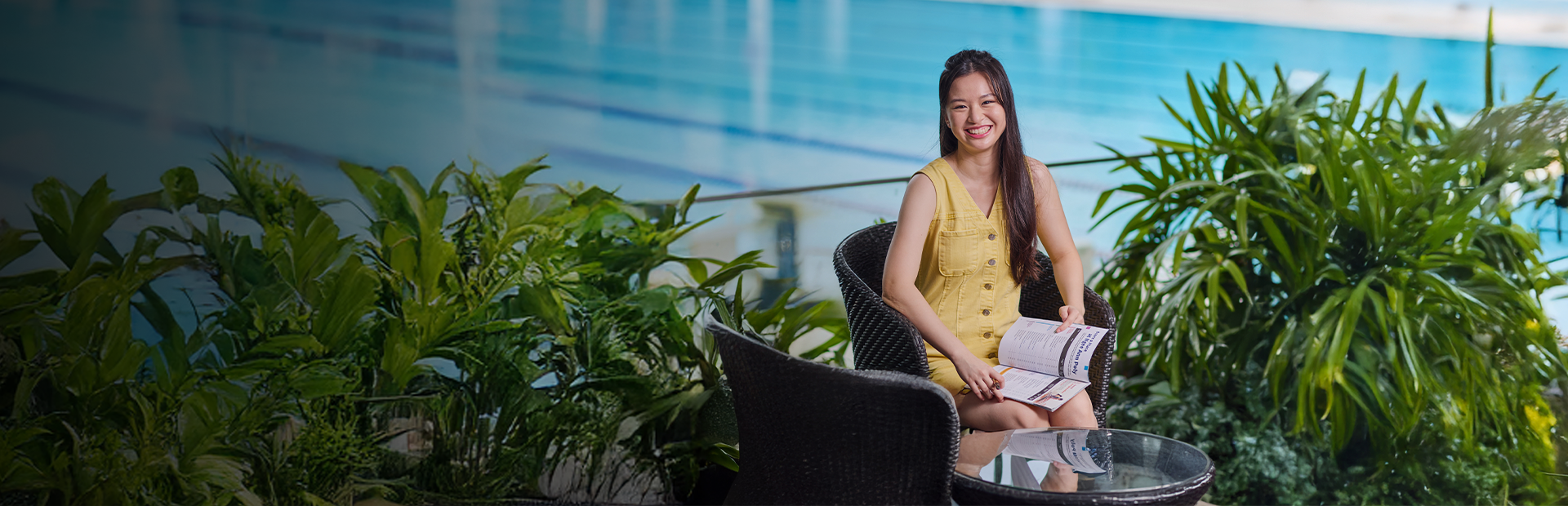 Photo of an NP student with a copy of the Ultimate Course Guide in her hand