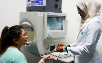 Optometrist conducting eye exam