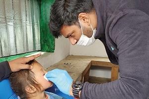 Student assisting child on eyecare