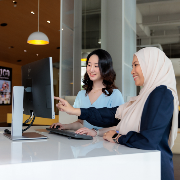 Staff assisting student at visitor center